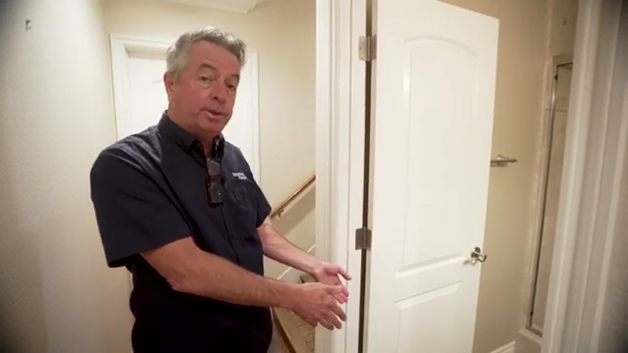 Leak detection technician explaining marked leak location to a homeowner in Flower Mound Texas