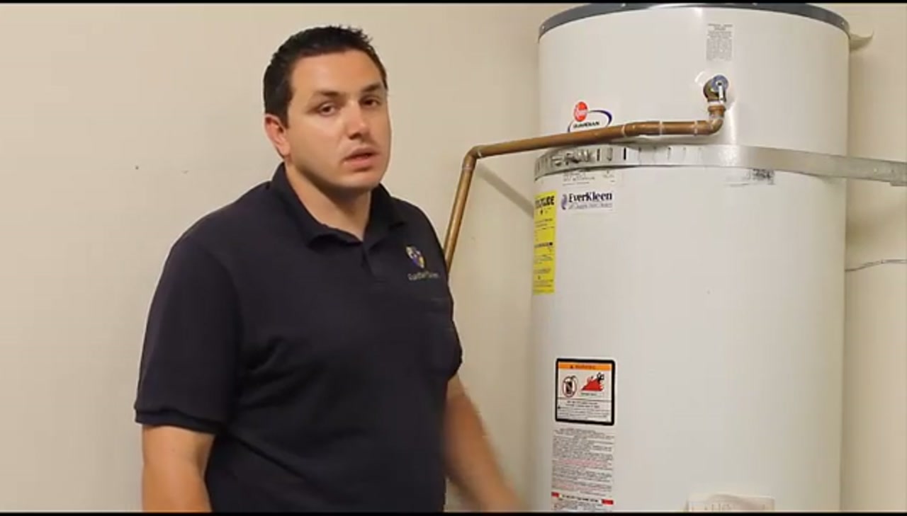 Technician checking a leaking water heater on an emergency call in Flower Mound Texas